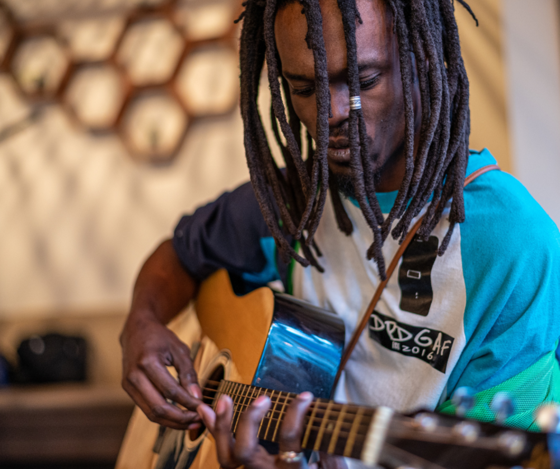 Caribbean man playing a guitar to reflect the music played on the radio station